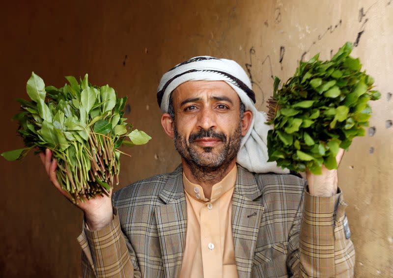 Vendor showsqat, a mild stimulant, as he waits for customers at a qat market amid concerns of the spread of the coronavirus disease (COVID-19) in Sanaa
