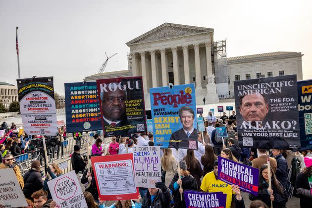 Demonstrators protest and argue outside the Supreme Court as justices hear arguments on FDA rules increasing access to the abortion drug mifepristone on March 26.