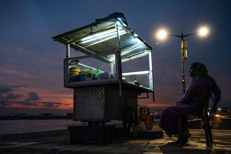 A street food vendor waits for customers at Galle Face Promenade in Colombo, Sri Lanka, on March 23, 2023. Many people visit Galle Face in the evening to exercise and enjoy street food. 