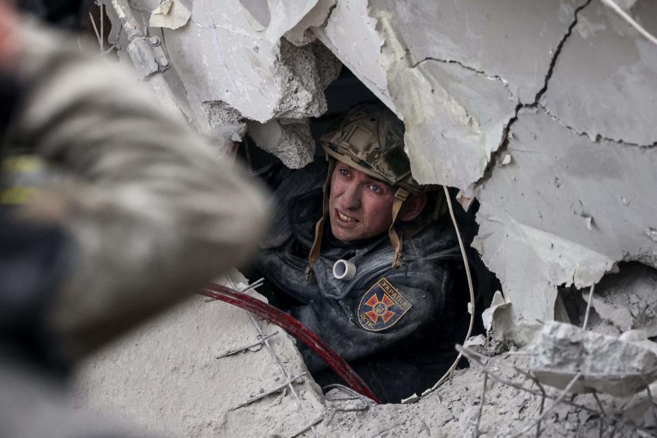 A rescuer searches for survivors in a partially destroyed residential building, after a shelling in Sloviansk, on April 14, 2023 (AFP via Getty Images)