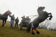 People wait with their horses the beginning of the annual race organized by Orthodox believers on Epiphany Day in the Romanian village of Pietrosani, 45 km (28 miles) north of Bucharest, January 6, 2014. Epiphany Day falls on January 6 every year and it celebrates the end of Christmas festivities in Romania. REUTERS/Bogdan Cristel (ROMANIA - Tags: ANIMALS SOCIETY RELIGION)