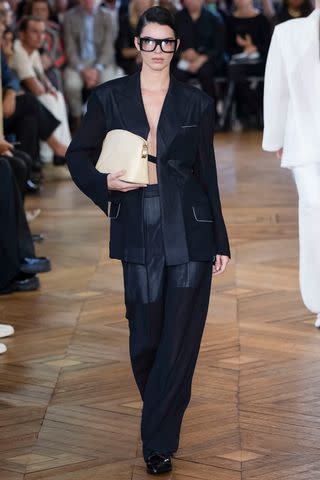 <p>Victor VIRGILE/Gamma-Rapho via Getty </p> Kendall Jenner walks the runway during the Victoria Beckham Ready to Wear Spring/Summer 2024 fashion show