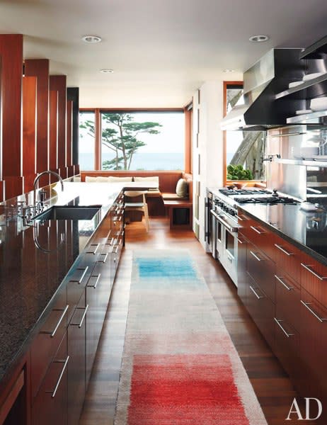 The galley-style kitchen features custom-made mahogany cabinetry and granite counters, Fisher & Paykel dishwasher drawers, a Sub-Zero wine cooler, and a Just stainless-steel sink with Dornbracht fittings; the runner was handwoven in Tibet. (Photo: David Matheson)