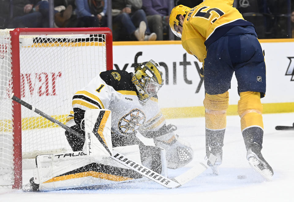 Boston Bruins goaltender Jeremy Swayman (1) stops a shot by Nashville Predators defenseman Kevin Gravel (5) during the second period of an NHL hockey game Thursday, Feb. 16, 2023, in Nashville, Tenn. (AP Photo/Mark Zaleski)