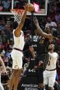 Miami Heat center Bam Adebayo (13) is pressured to pass the ball by Cleveland Cavaliers center Evan Mobley (4) during the first half of an NBA basketball game, Friday, March 11, 2022, in Miami. (AP Photo/Marta Lavandier)