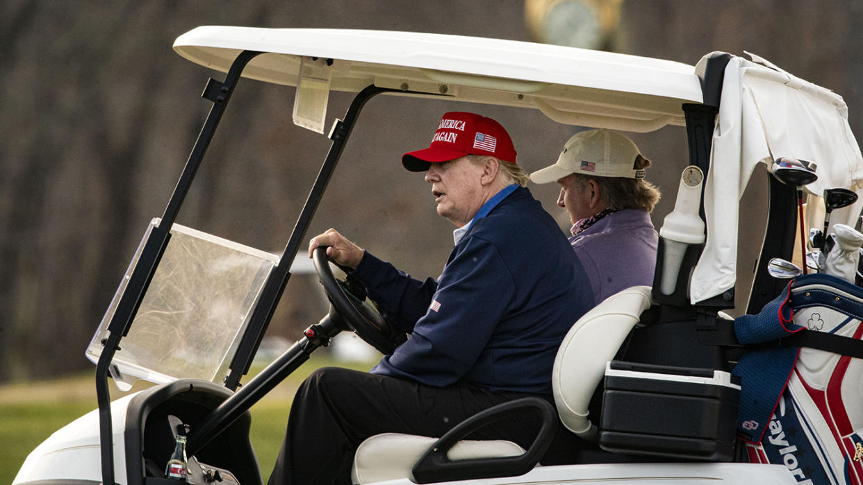 President Trump drives a golf cart at his club in Sterling, Va., Sunday. (Photo by Al Drago/Getty Images)
