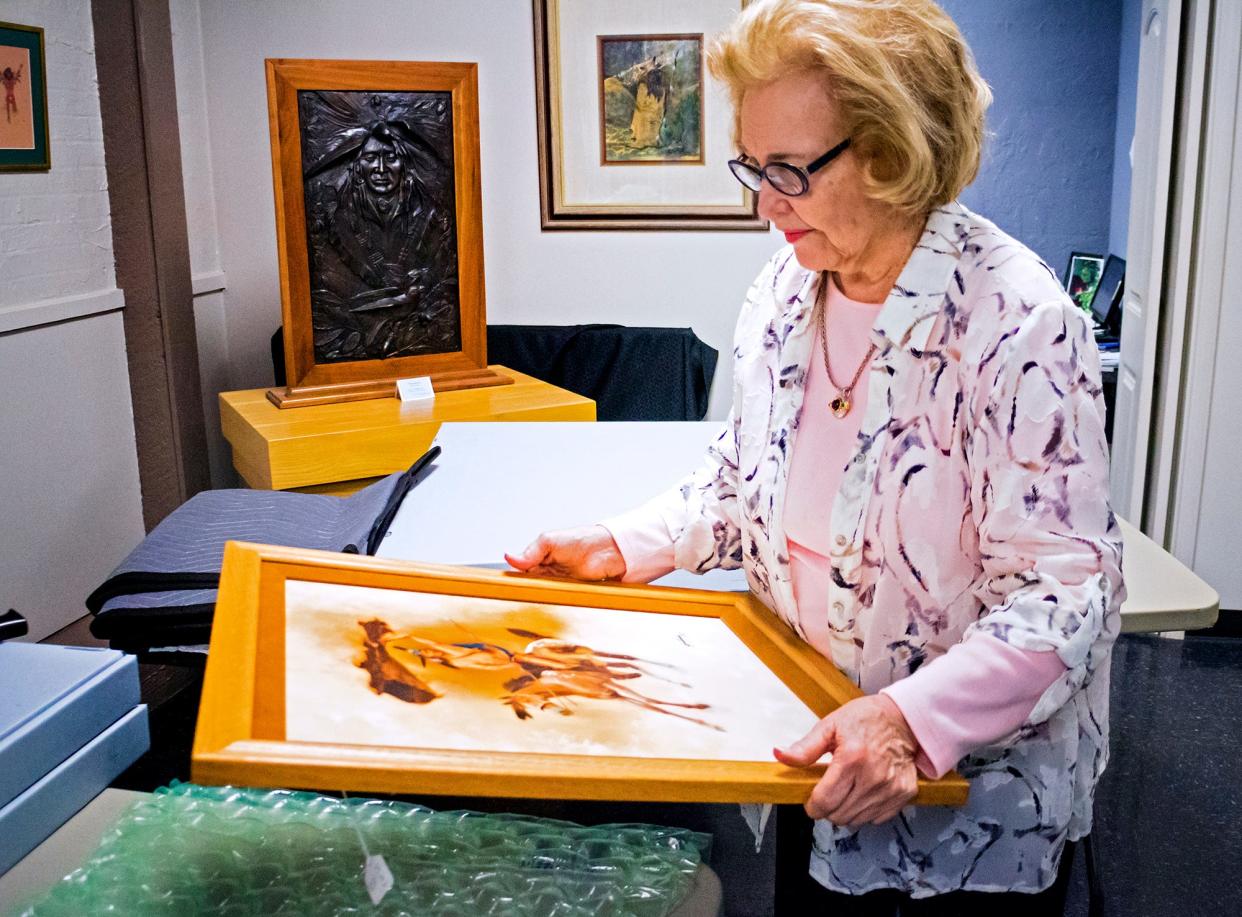 Lou Kerr packs artwork at the Red Earth Art Center in 2019. Kerr died Thursday at the age of 87.