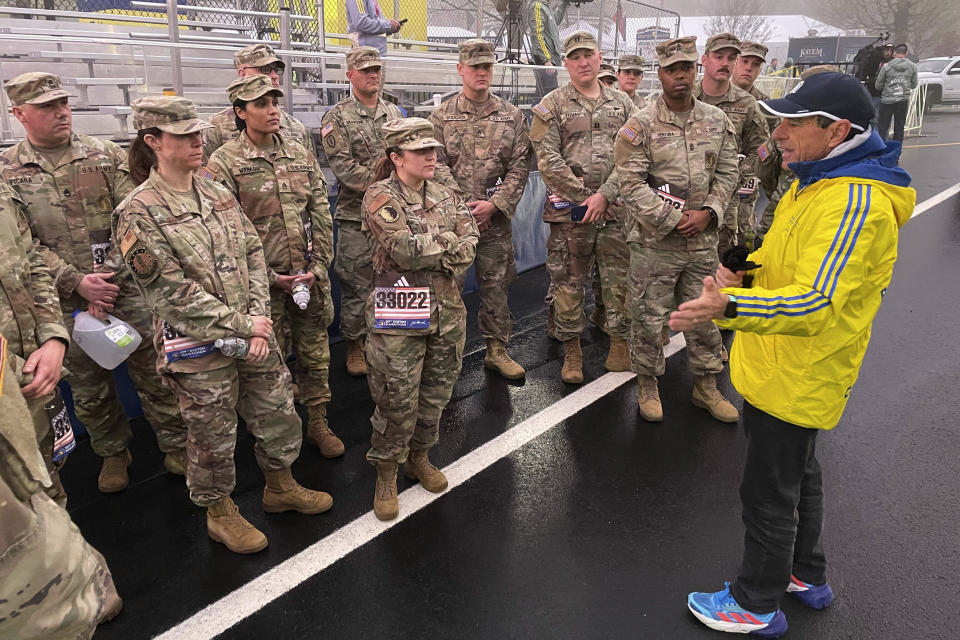 Boston Marathon Race Director Dave McGillivray talks to a group of about 20 from the Massachusetts National Guard, which walks the course annually, announcing the start of the 127th marathon Monday, April 17, 2018. (AP Photo/Jennifer McDermott)