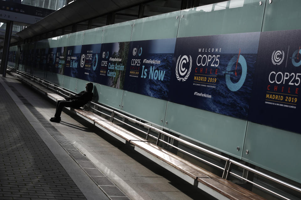 A man sits at the COP25 climate talks congress in Madrid, Spain, Saturday, Dec. 14, 2019. The United Nations Secretary-General has warned that failure to tackle global warming could result in economic disaster. (AP Photo/Manu Fernandez)