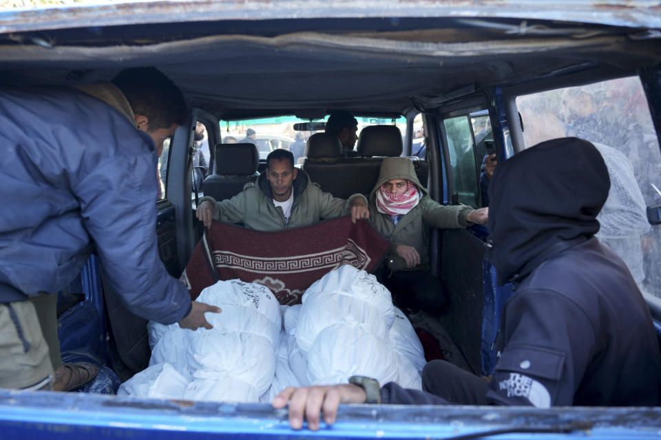 Palestinians transport their relatives killed in the Israeli bombardment of the Gaza Strip in Deir al Balah, Monday, Feb. 5, 2024. (AP Photo/Adel Hana)