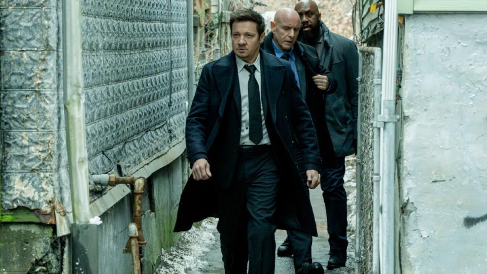 L-R: Jeremy Renner as Mike McLusky, Hugh Dillon as Ian and Derek Webster as Stevie walking down an alley in Mayor of Kingstown Season 3.