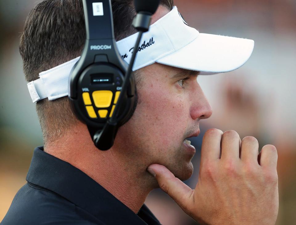 Green football coach Mark Geis watches the action against Ellet during a home game Aug. 19, 2022.