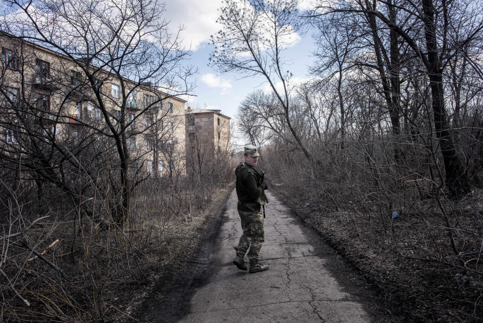 A Ukrainian solder patrols in the village of Zolote 4, eastern Ukraine, Friday, March 29, 2019. Five years after a deadly separatist conflict in eastern Ukraine, a generation of first-time voters in the rebel-held Donetsk and Luhansk areas has been cut off from Sunday's Ukrainian presidential election. (AP Photo/Evgeniy Maloletka)