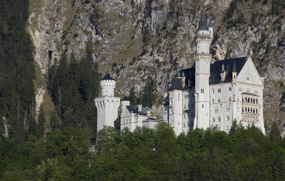 FILE - Castle Neuschwanstein, a 19th century creation by Bavaria's fairy tale king Ludwig II and world renowned tourist attraction, is pictured in Hohenschwangau near Fuessen, southern Germany, on May 9, 2011. Voters in the municipality where the castle is located have voted to approve a bid for UNESCO World Heritage status for the 19th century palaces built by King Ludwig II of Bavaria, some of which are among Germany's most popular tourist attractions. Voters gave their approval to the bid in a referendum on Sunday, June 18, 2023, German news agency dpa reported. (AP Photo/Matthias Schrader, File)