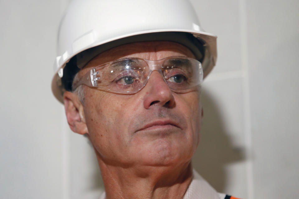 Baseball Commissioner Rob Manfred listens to a question during a tour of the under construction new Texas Rangers stadium in Arlington, Texas, Tuesday, Nov. 19, 2019. Manfred hopes the investigation into sign stealing by the Houston Astros will be completed by next season and says he has broad authority to impose discipline beyond fines, the loss of amateur draft picks and taking away international signing bonus pool allocation. (AP Photo/LM Otero)