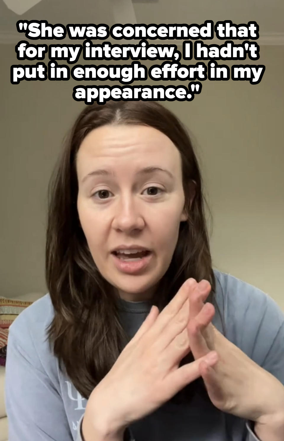 Woman gesturing with hands in a discussion, possibly in a work-related video call