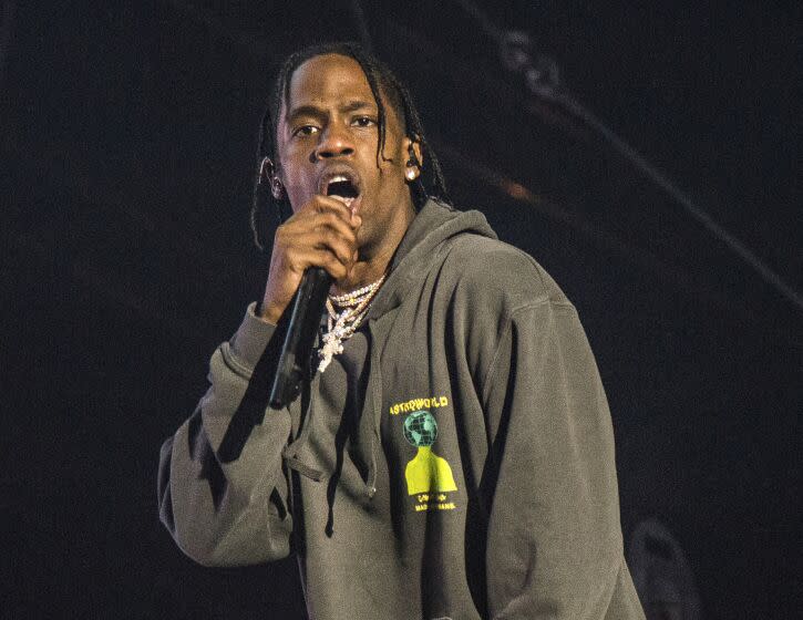 FILE - This March 3, 2018 file photo shows Travis Scott performing at the Okeechobee Music and Arts Festival on Saturday, March 3, 2018, in Okeechobee, Fla. Scott and Cardi B are heading to the City of Brotherly Love to headline Jay-Z's annual Made in America festival in Philadelphia over Labor Day weekend. (Photo by Amy Harris/Invision/AP)