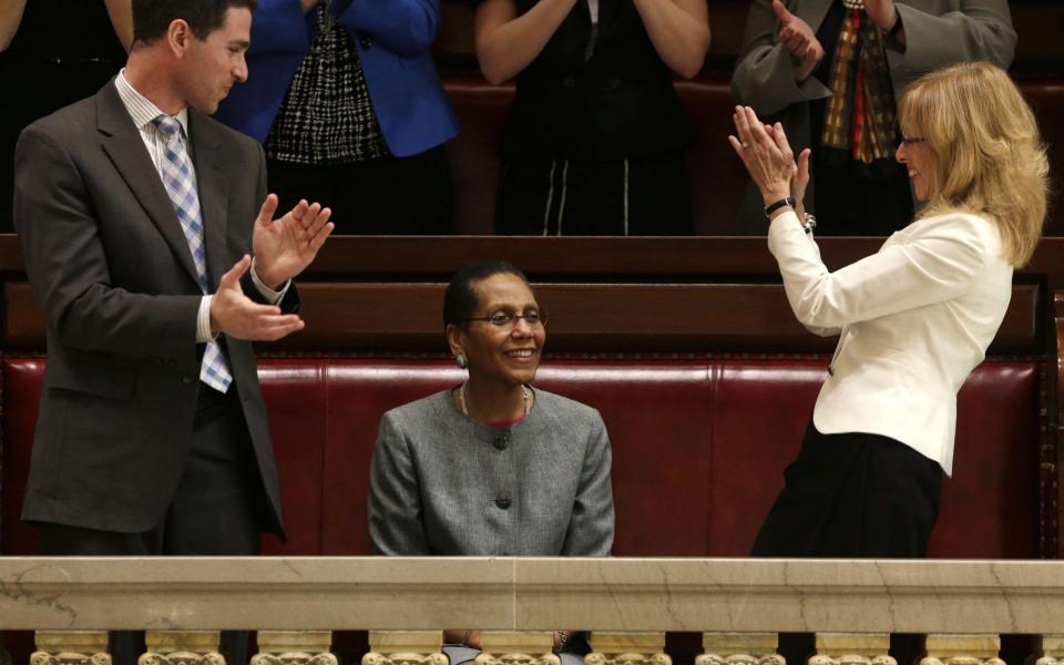 Sheila Abdus-Salaam, centre, receives applause after her confirmation to serve on the New York State Court of Appeals - Credit: AP