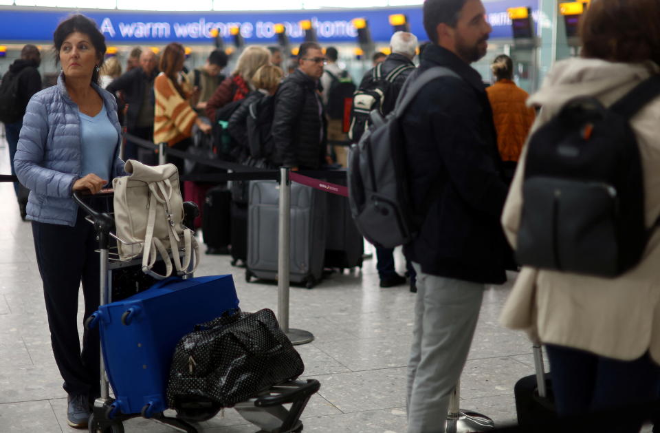 Passengers queue for the check in desk at Heathrow Terminal 5 airport in London, Britain, June 1, 2022.REUTERS/Hannah McKay