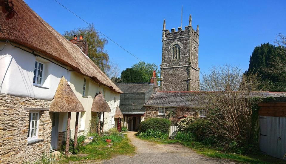 Fern Cottage is a rental in Cornwall that travelers can book to see the film location of “Doc Martin”. 
Pictured: a cottage and gravel road in Cornwall