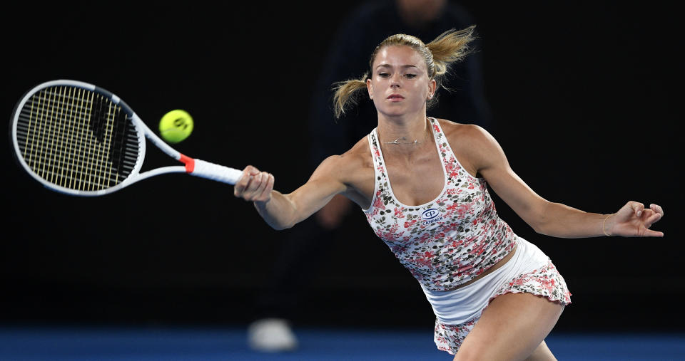 Italy's Camila Giorgi makes a forehand return to Karolina Pliskova of the Czech Republic during their third round match at the Australian Open tennis championships in Melbourne, Australia, Saturday, Jan. 19, 2019. (AP Photo/Andy Brownbill)