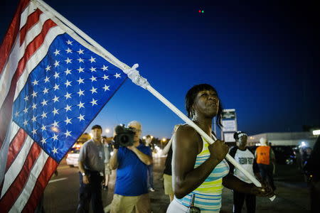 An anti-police demonstrator marches in protest in Ferguson, Missouri August 10, 2015. REUTERS/Lucas Jackson