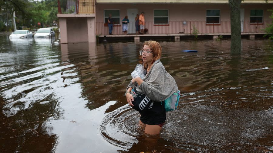 Makatla Ritchter wades through flood waters after having to evacuate her home when the flood waters from Hurricane Idalia inundated it on August 30, 2023 in Tarpon Springs, Florida. (Photo by Joe Raedle/Getty Images)