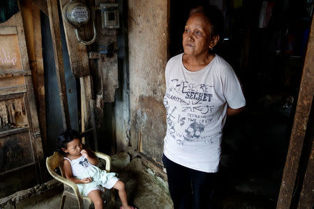 Clarita Alia, 62, stands at her home while talking about her four sons which have died in execution-style killings in Davao, Philippines May 14, 2016. REUTERS/Andrew RC Marshall