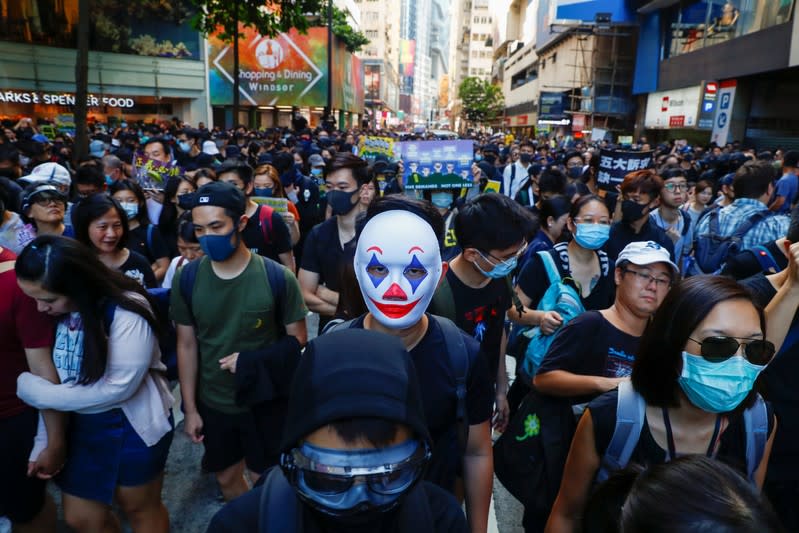 People protest during a march billed as a global "emergency call" for autonomy next to the Causeway Bay shopping district in Hong Kong