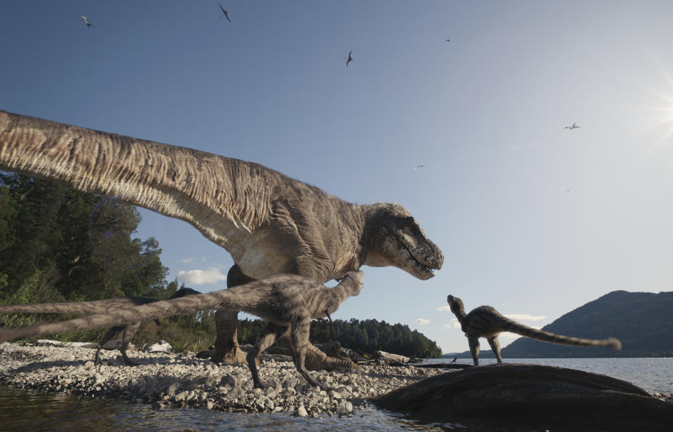 This image provided by Giant Screen Films and taken from the film "T.REX,” shows a mother T. rex and her young. (Courtesy of Giant Screen Films via AP)