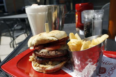 A meal of a "Monster"-sized A.1. Peppercorn burger, Bottomless Steak Fries, and Monster Salted Caramel Milkshake is seen at a Red Robin restaurant in Foxboro, Massachusetts July 30, 2014. REUTERS/Dominick Reuter/Files