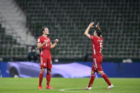 Bayern's Leon Goretzka, left, and Bayern's Benjamin Pavard celebrate end of the German Bundesliga soccer match between Werder Bremen and Bayern Munich in Bremen, Germany, Tuesday, June 16, 2020. Because of the coronavirus outbreak all soccer matches of the German Bundesliga take place without spectators. Bayern Munich secured its eighth successive German Bundesliga title Tuesday with two games to spare after beating Werder Bremen 1-0 with a goal from Robert Lewandowski. (AP Photo/Martin Meissner, Pool)