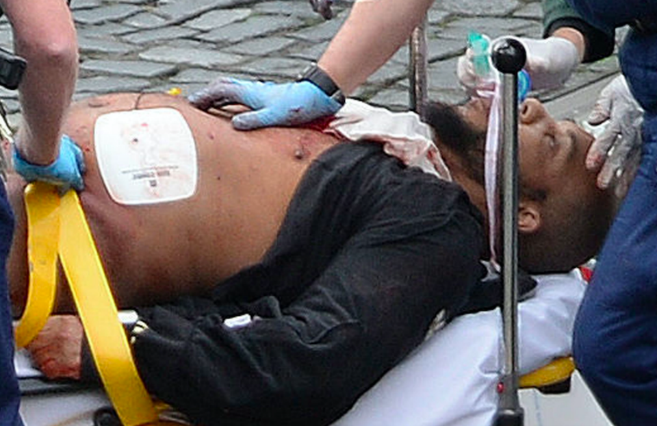 The man suspected of the London terror attack is treated at the scene by paramedics. Photo: AAP