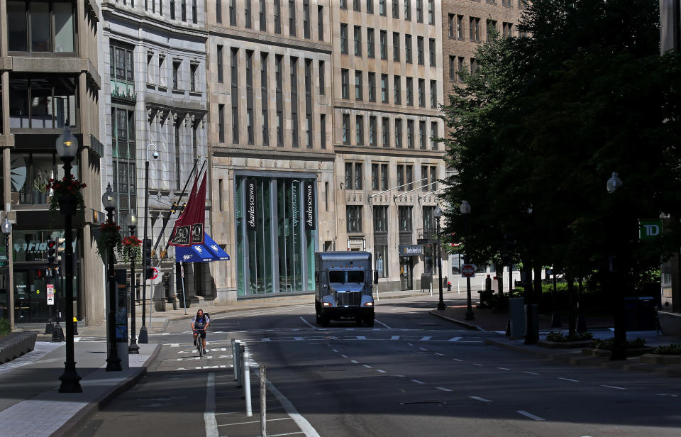 BOSTON - JULY 30: Few pedestrians and cars traverse Congress Street in Boston's financial district around 10 a.m. on July 30, 2020. Downtown Boston and the normally-bustling Financial District that is a ghost town this summer during the COVID-19 pandemic. (Photo by David L. Ryan/The Boston Globe via Getty Images)