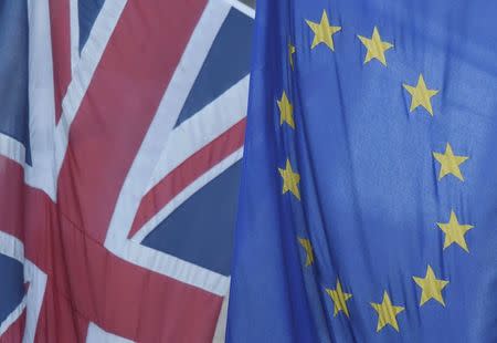 A Union flag flies next to the flag of the European Union in Westminster, London, Britain June 24, 2016. REUTERS/Toby Melville/File Photo