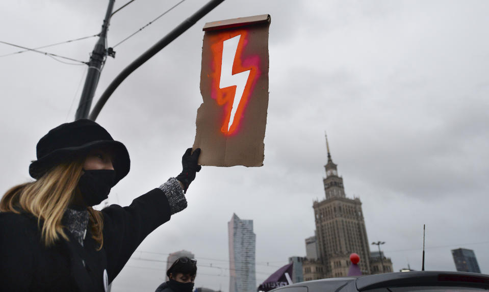 People demonstrate against police violence and an attempted restriction on abortion rights in Warsaw Poland, Saturday, Nov. 28, 2020. Nationwide protests Saturday were scheduled to coincide with Polish women gaining the right to vote 102 years ago. Weeks of protests against a high court's ruling to further restrict Abortion rights have evolved into the largest protest movement since communism fell 30 years ago.(AP Photo/Czarek Sokolowski)