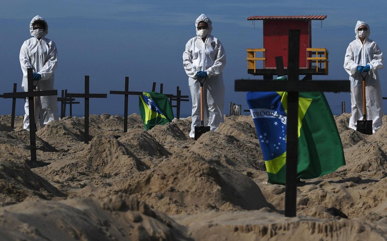 Protesters on Copacabana beach in Rio de Janeiro dug 100 mock graves to protest bad governance -  CARL DE SOUZA/AFP