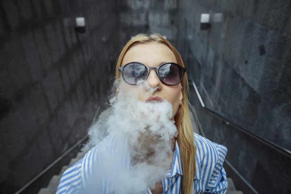 woman vaping on the street