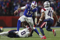 Buffalo Bills quarterback Josh Allen (17) gets past New England Patriots middle linebacker Ja'Whaun Bentley (8) with Patriots cornerback Myles Bryant (41) closing in to force him out of bounds during the second half of an NFL football game in Orchard Park, N.Y., Monday, Dec. 6, 2021. (AP Photo/Joshua Bessex)