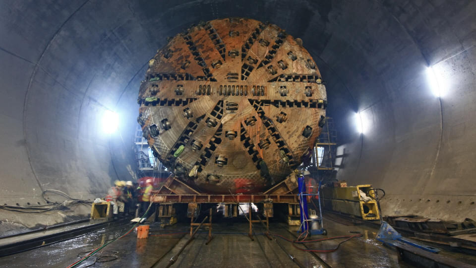Tunnel Boring Machine (TBM) )that is being moved inside an underground tunnel.