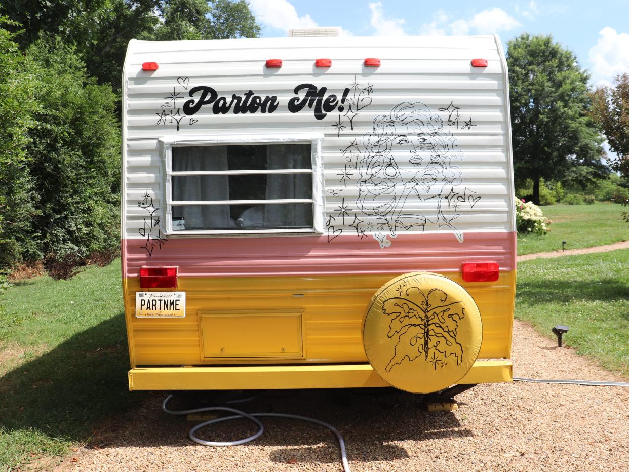 A Dolly Parton-themed RV that says "Parton Me!" on the back