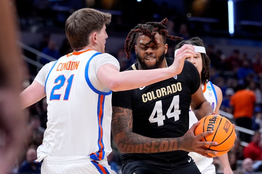 Colorado center Eddie Lampkin Jr. (44) drives around Florida forward Alex Condon (21) in the second half of a first-round college basketball game in the NCAA Tournament, Friday, March 22, 2024, in Indianapolis, Ind. (AP Photo/Michael Conroy)