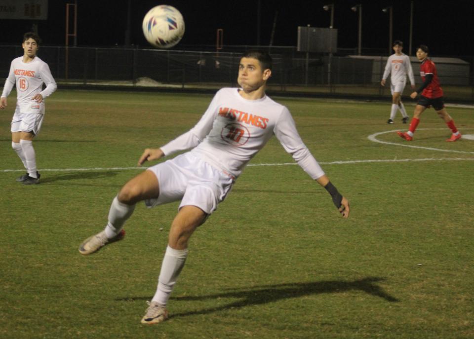 Mandarin midfielder Omar Trto (10) prepares to strike a volley against Creekside.