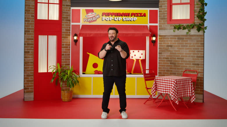 Adam Richman standing in front of pepperoni store