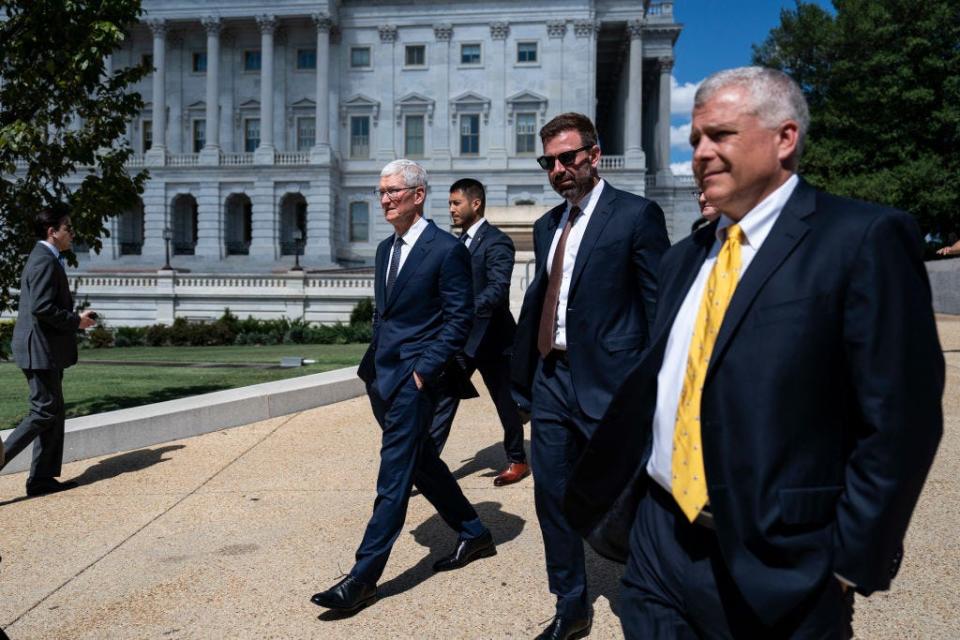 Apple CEO Tim Cook walks outside