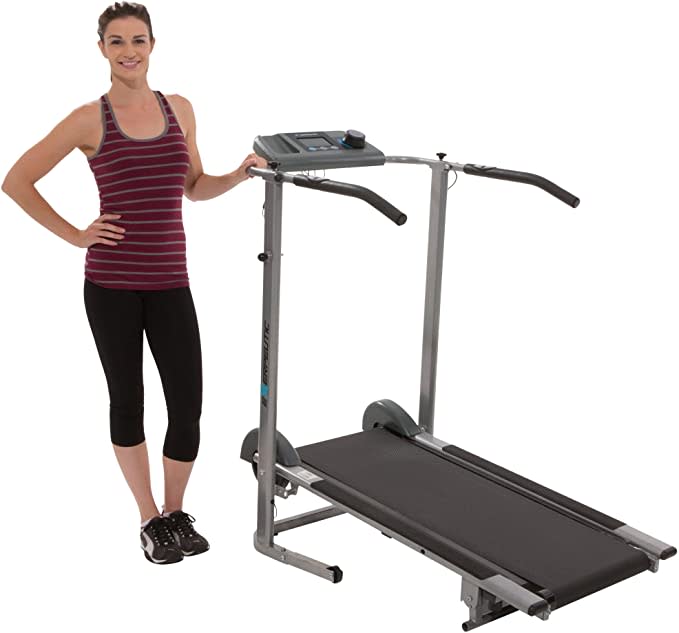 woman standing next to exerpeutic treadmill on white background