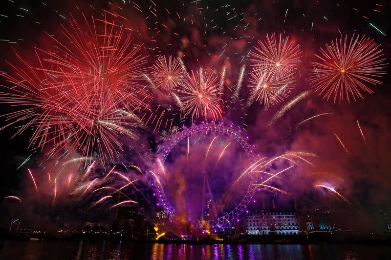 Fireworks explode over the London Eye wheel during New Year celebrations in central London