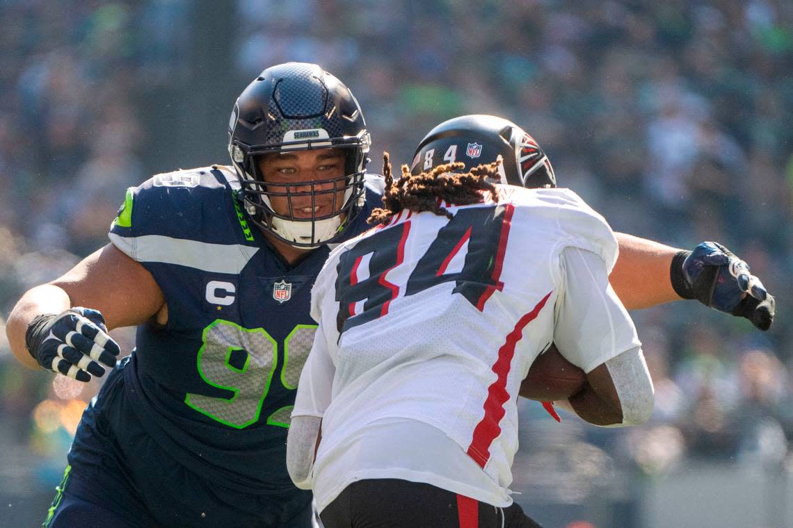 Seattle Seahawks defensive tackle Al Woods (99) gets in position to tackle Atlanta Falcons running back Cordarrelle Patterson (84) behind the line of scrimmage on a rushing play in the second quarter of an NFL game on Sunday, Sept. 25, 2022, at Lumen Field in Seattle.