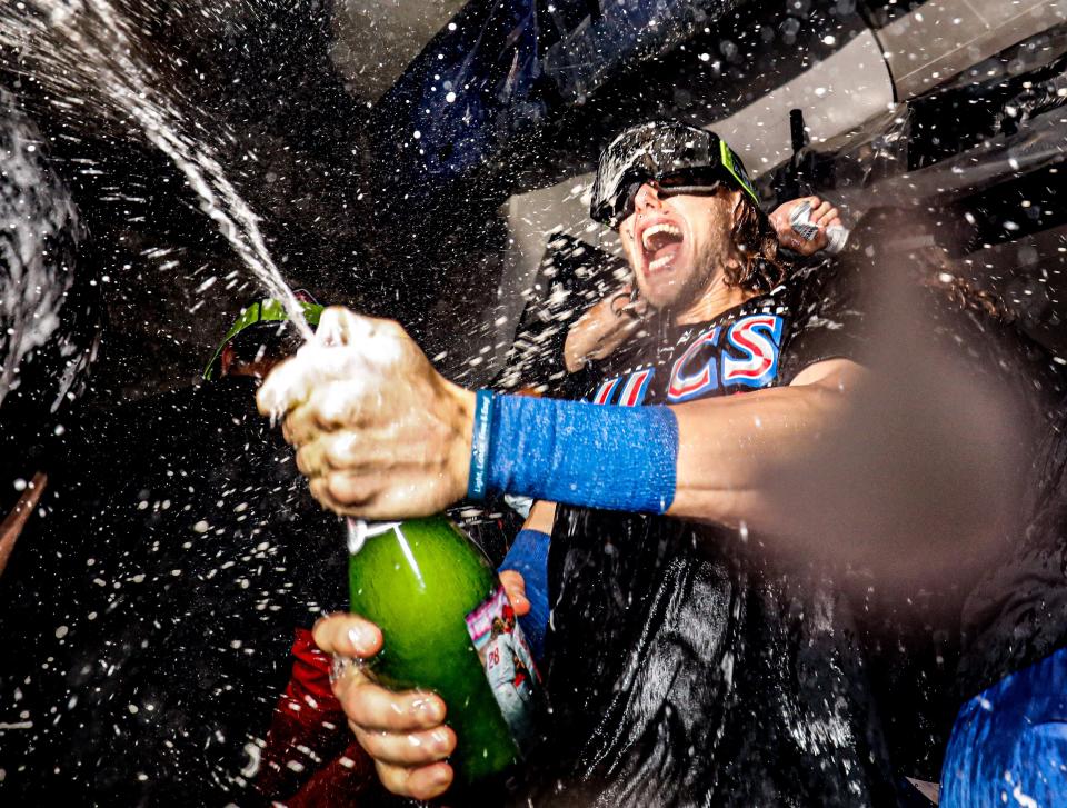 Phillies third baseman Alec Bohm sprays champagne in the locker room after Philadelphia defeated the Atlanta Braves to advance to the NLCS.