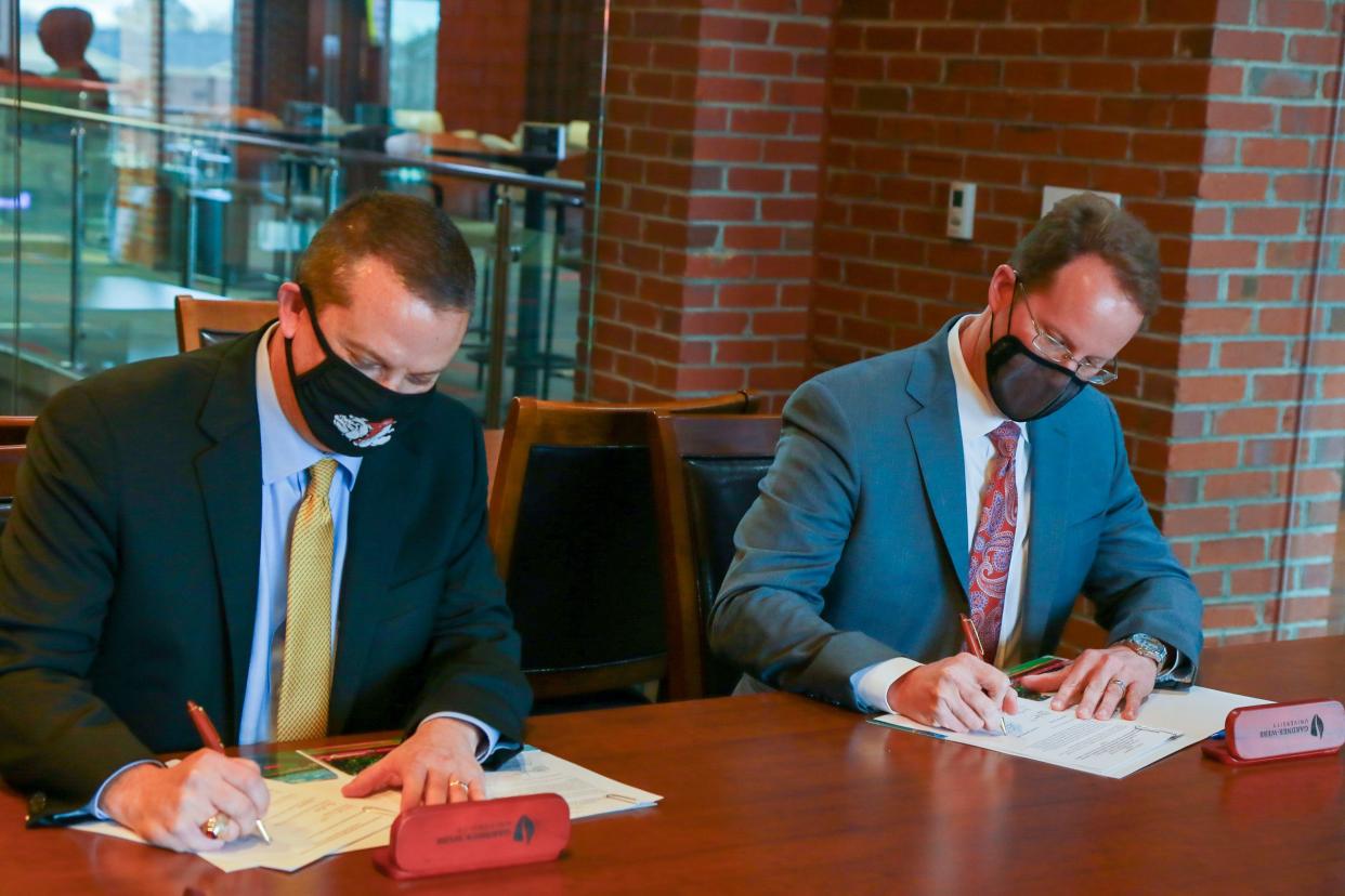 Gardner-Webb University and Cleveland Community College presidents William Downs and Jason Hurst sign agreements for a joint admissions program for nursing students in this Star file photo.
